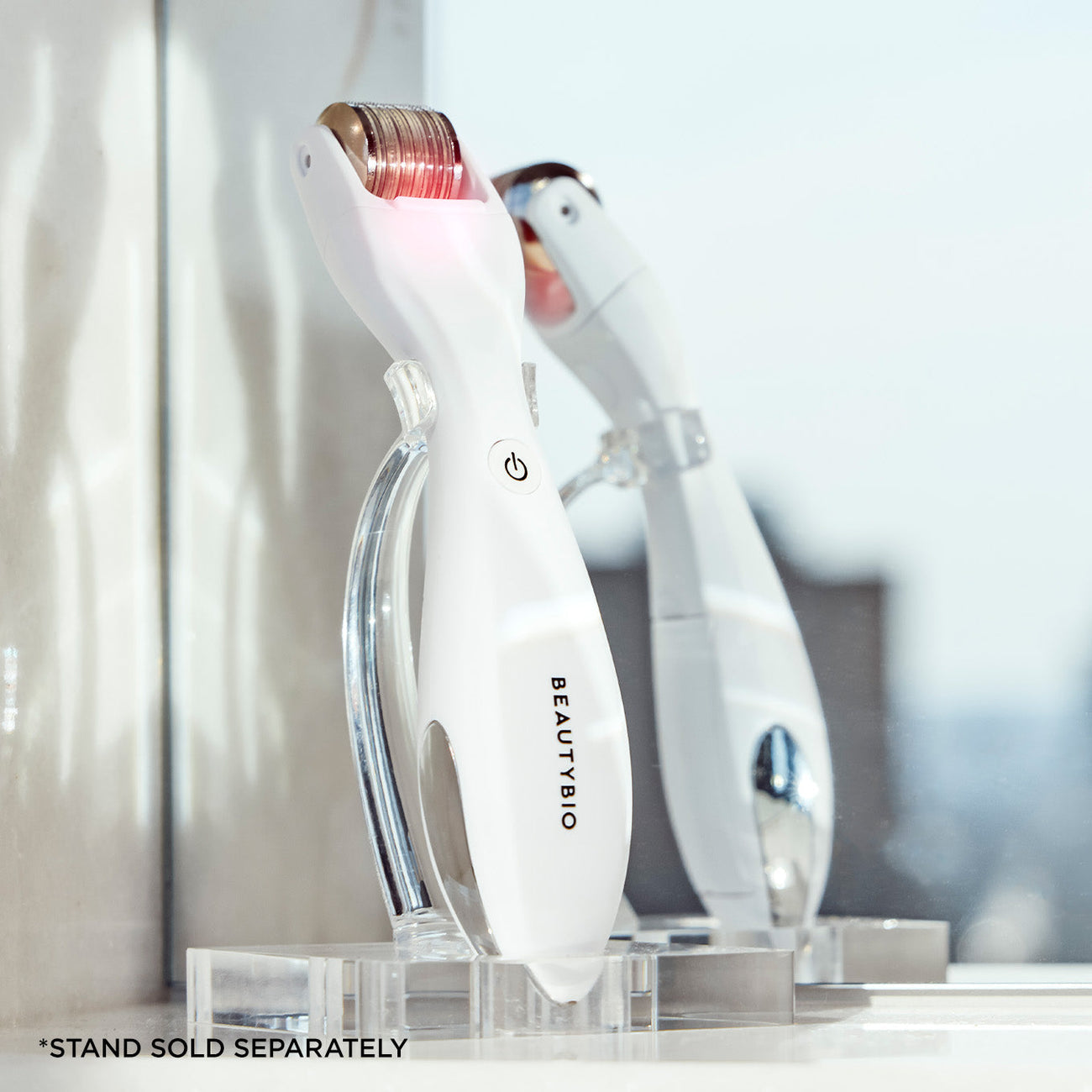 Beauty device with 'BEAUTY BIO' branding on a clear stand against a blurred background