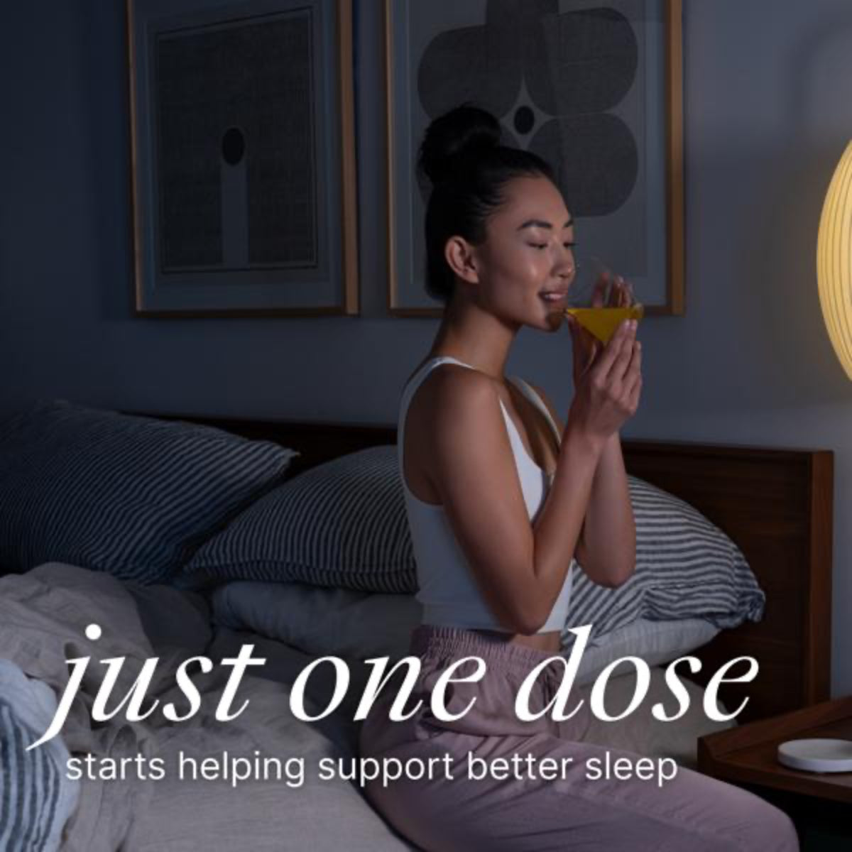 Woman sitting on a bed holding a supplement with text 'just one dose' in a bedroom setting.