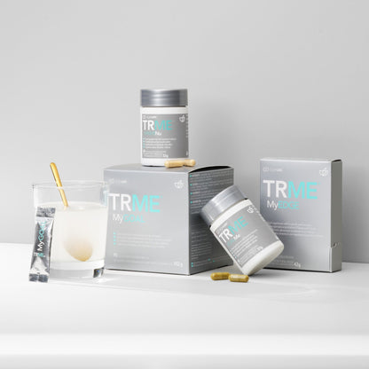 A set of Nu Skin AgeLOC TRME wellness management kit products, including containers and boxes with branding visible.
