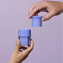Two hands holding blue containers against a purple background