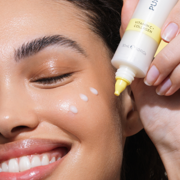 Person applying a skincare product to their face with a close-up view.